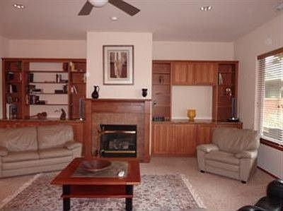 Great room is open to dining area for flexible space options. Custom built-ins surround the gas fire