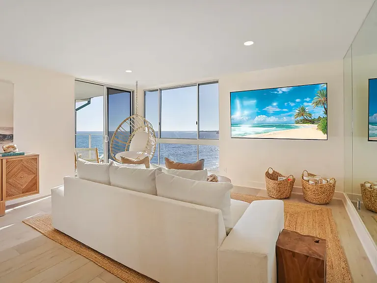Lounge in comfort while soaking up the ocean view, perfectly framed by floor-to-ceiling windows.