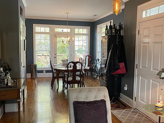 View of entrance and dining room from living room. Glass doors lead to backyard.