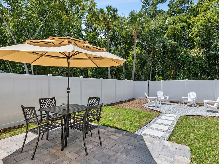 Backyard patio dining area, fully fenced, secure and private. Fire pit is now installed and plants/trees/bushes are in progress now!