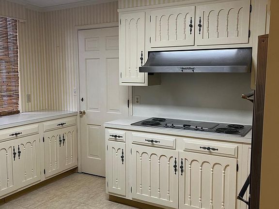 Kitchen with lovely historic details on the cabinets, electric cooking range with griddle