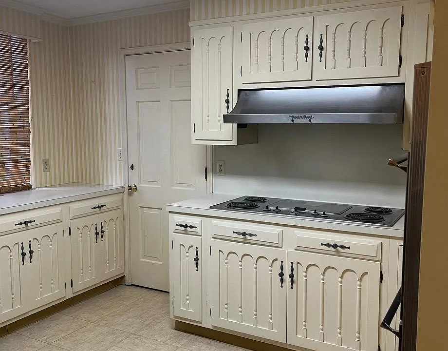 Kitchen with lovely historic details on the cabinets, electric cooking range with griddle