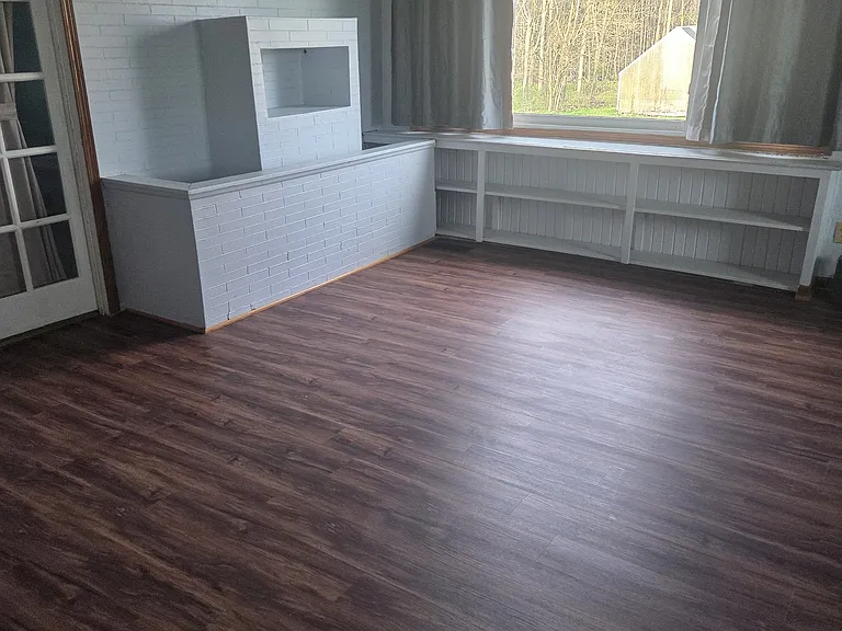 Spacious Living Room with Faux Brick Accent & Large Picture Window