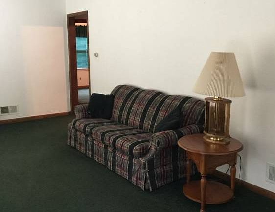 Very large living room with a large window.