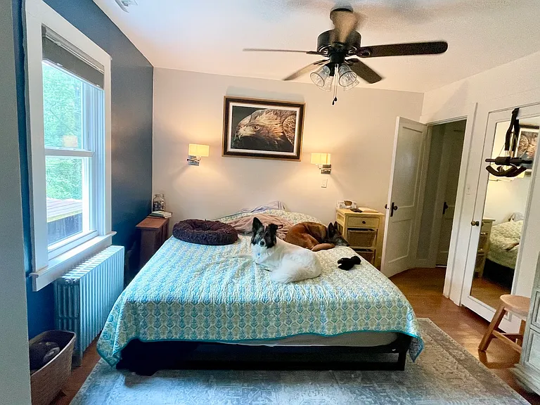 Master bedroom with a king-size bed. It is low due to an older dog I once had.