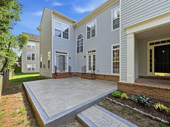 Private backyard patio accessible from both the sitting room and family room - perfect for outdoor dining and entertaining