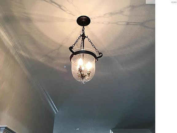 This villa home has beautiful light fixtures throughout. Pictured here is the entry way light.
