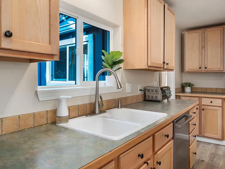 Open concept kitchen a bar with all stainless steel appliances and ample cabinet space