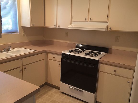 Bright, cherry kitchen with separate laundry off kitchen