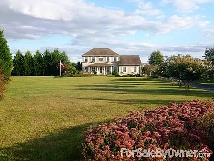 Home Front
						:
						Home with front porch sits back from cul-de-sac with a 200' tree lined driveway.
