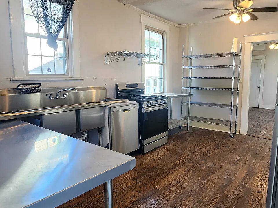 View of kitchen from backdoor of apartment.

New oven
New dishwasher
New fridge
Cabinets are on opposite side