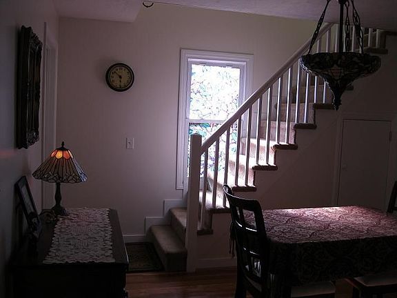stairway to upstairs bedroom with 1/2 bath
