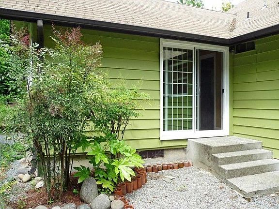 Slider from master bedroom to back courtyard area. Beautiful location and greenery with lots of ligh