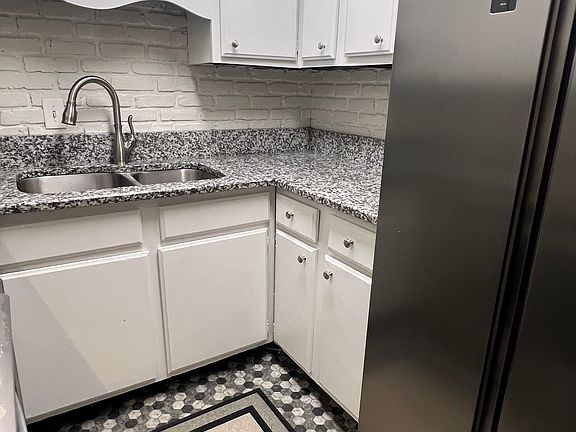 Counter-depth stainless steel double door refrigerator and new tile floor