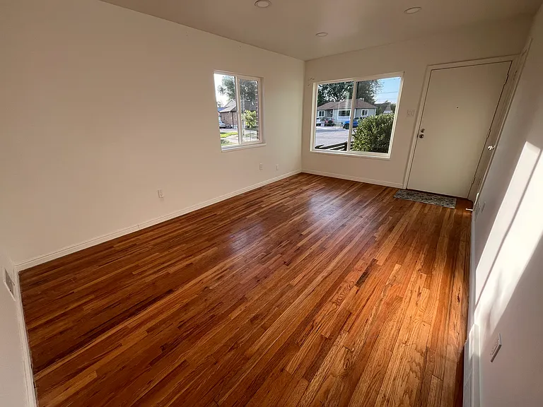 Living room with new windows and hardwood floors
