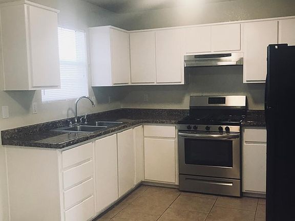 Kitchen with gas stove & refrigerator