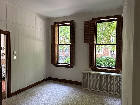 Living room off foyer looking outside.
Carpet and high ceilings. Windows have shutters to close for privacy. RADIATOR HEAT is included in rent