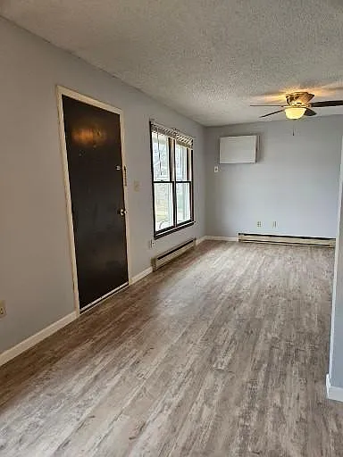 Looking from dining area to living room, entry door.