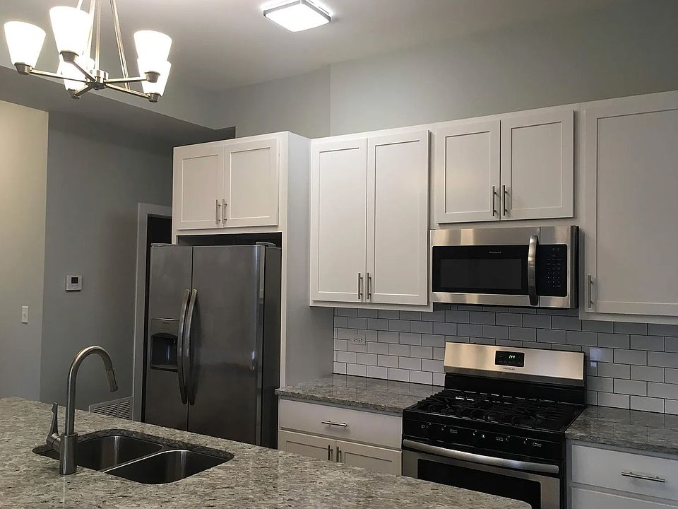 Beautiful remodeled kitchen with granite countertops, dishwasher, upgraded fridge, and gas stove/oven