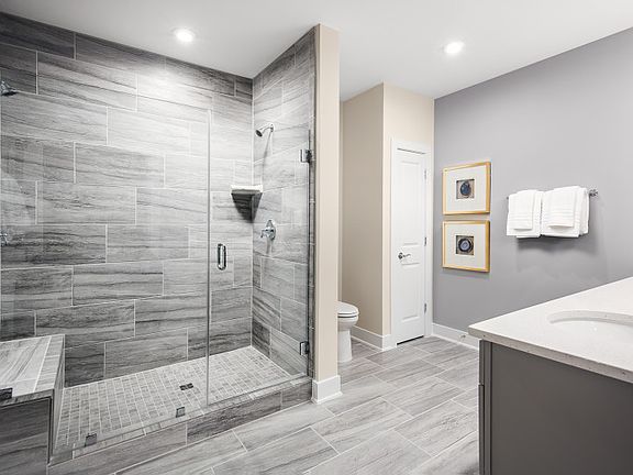 Owner s Bath with Dual Sinks and a Frameless Walk-in Shower