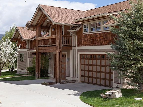 angled view of west side of home; 3 car garage; side entrance; long driveway