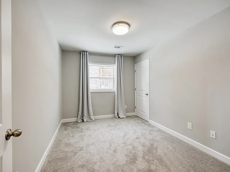 Cozy third bedroom, ideal for a home office or guest room.