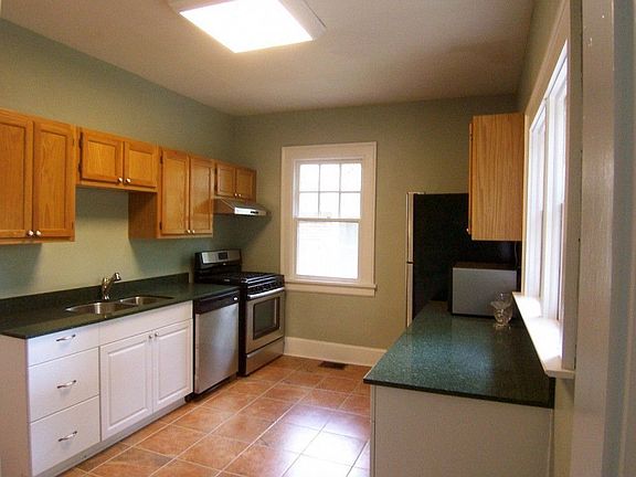 Updated kitchen features new granite counters and ceramic tile floor