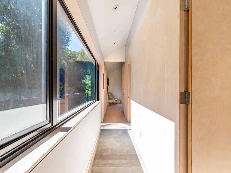 Upstairs hallway to bedroom and bridge to upper path, hot tub and Casita