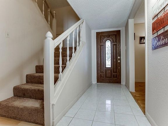 View from living area to front door and stairway
