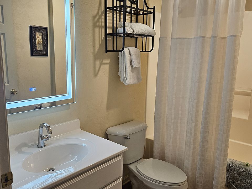 Updated bathroom with lighted mirror