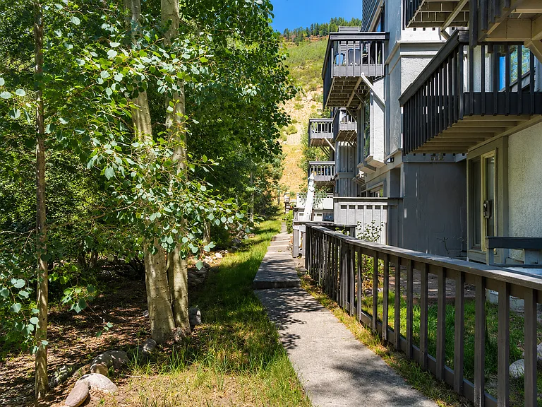 Quiet tree-lined walkway to unit