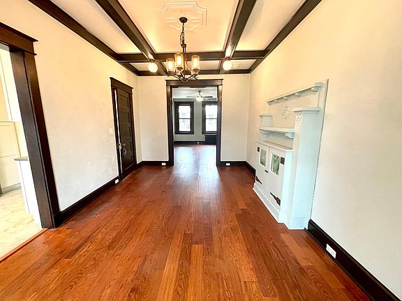 Huge Dining Room w/ Coffered Ceiling, High Ceilings, Wood Floors and Built-in Buffet.