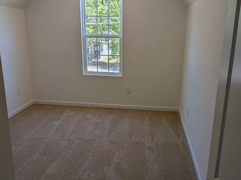 One of four bedrooms located on the second level, providing comfort and versatility.