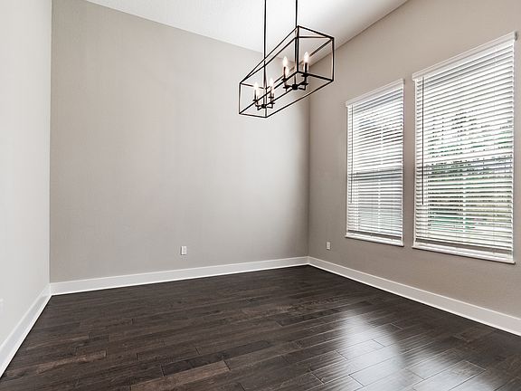 Formal dining room with a black iron chandelier