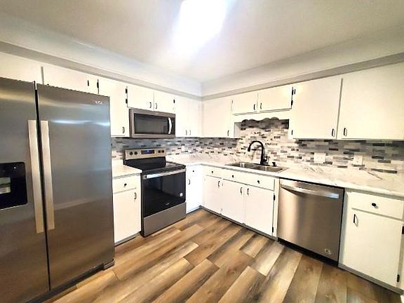 Renovated kitchen with all new counters, stainless steel appliances, and updated hardware