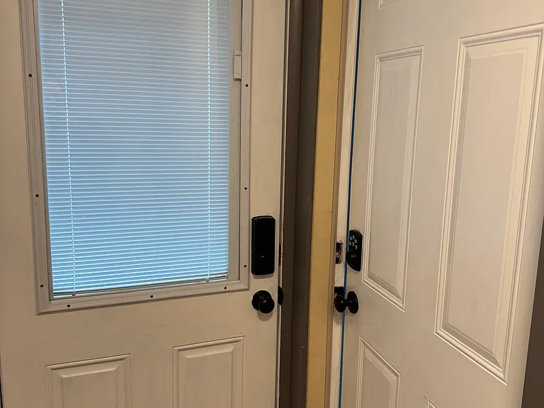 separately lockable doors to back door hall and to main floor.