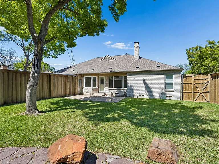 Private, well-maintained backyard with 8-foot fence.