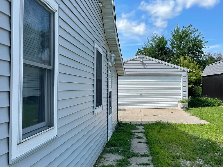2 car garage with garage door opener and the back door in the kitchen