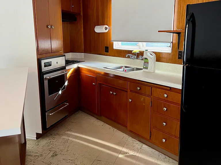 Kitchen, oven, stove hood fan and refrigerator
