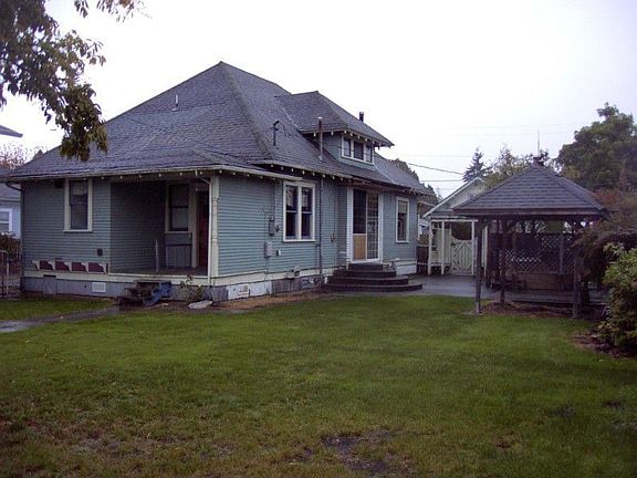 Back of the home showing hot tub room on the right and small back porch.
