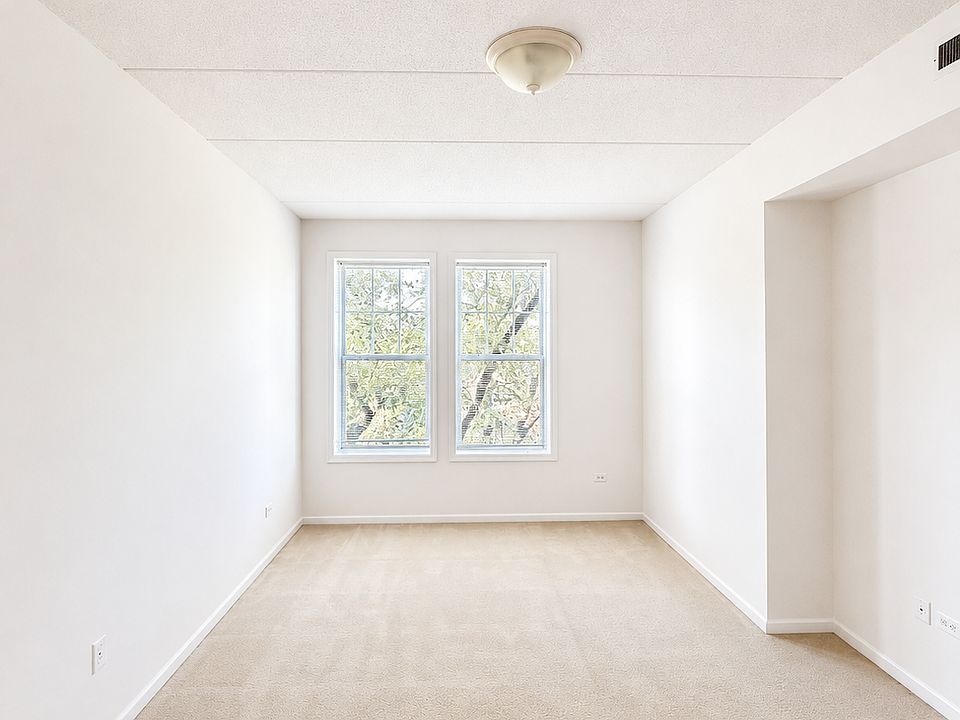 Primary bedroom with the view of quiet and green street
