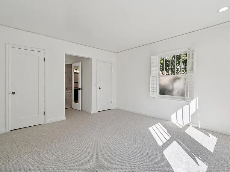 different pov of primary bedroom with 2 walk-in closets.