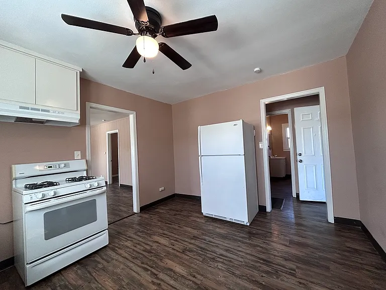 Kitchen, frig, backdoor entrance, hallway to bath and 2nd bedroom