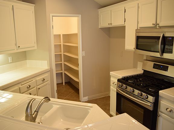 Sought after additional storage with a walk in pantry & built in shelves. Refrigerator included