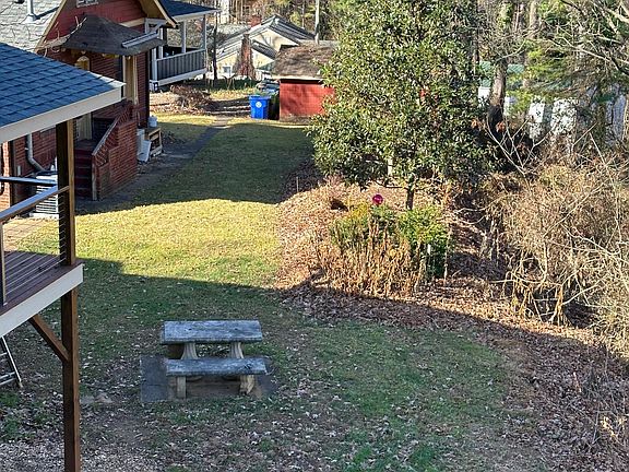 View from the porch of the neighborhood yards and flower beds.