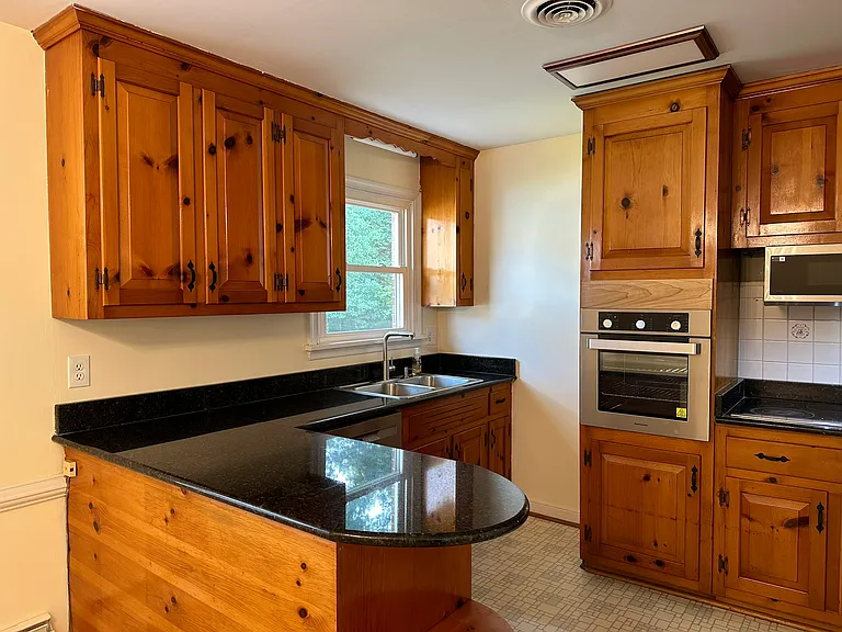 Restored kitchen cabinets with new modern appliances.