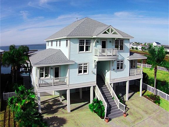 Christmas Tree Point side of home with mature tropical landscaping.