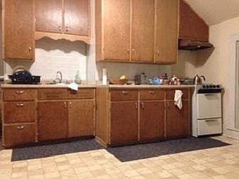 Standing in the entry looking at the kitchen cabinets.