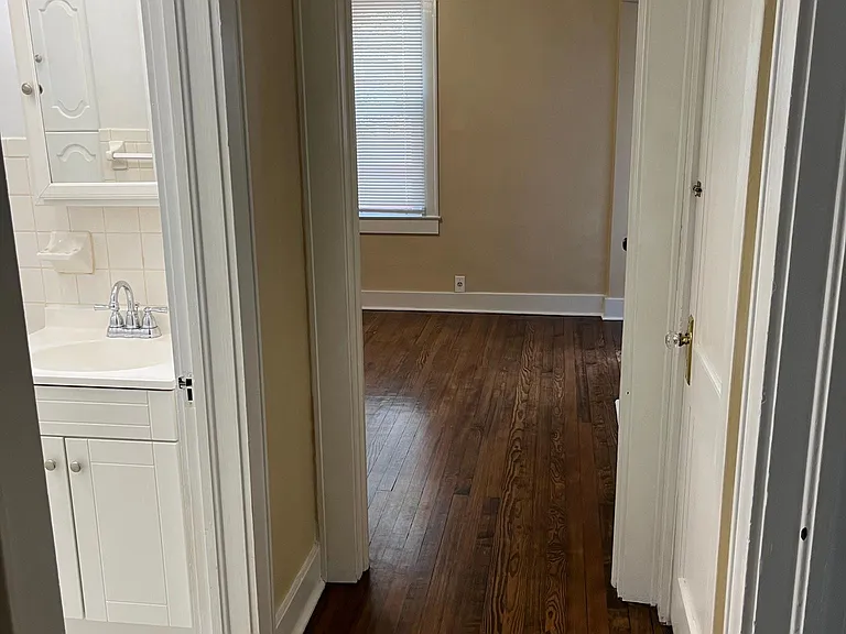 First floor hallway leading to bathroom and dining room/office.