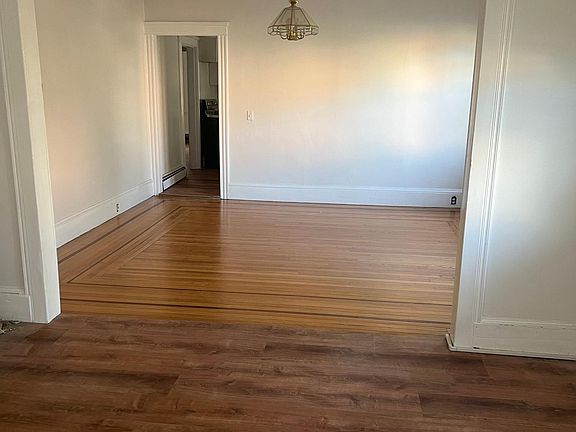 Well lit over size living room and a large dining to the far end having original hardwood floor.